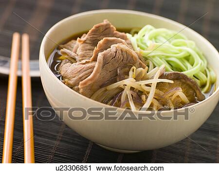 Stock Image - Hot and Sour Beef Broth With Spinach Ramen Noodles. Fotosearch