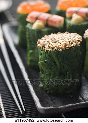 Stock Image - Rolled Spinach Three Ways-Snow Crab Toasted Sesame Seeds and salmon Roe. Fotosearch