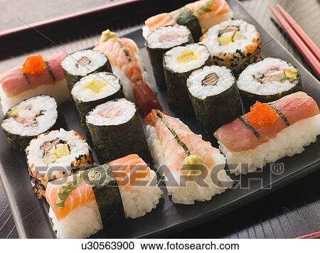Stock Image - Selection of Seafood and Vegetable Sushi on a Tray with chopsticks. Fotosearch