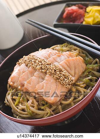 Stock Photo - Sesame Crusted Salmon Fried Noodles and Pickles. Fotosearch