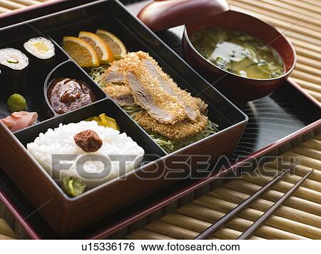 Stock Photograph - Tonkatsu Box and Miso Soup with Pickles and Sushi. Fotosearch