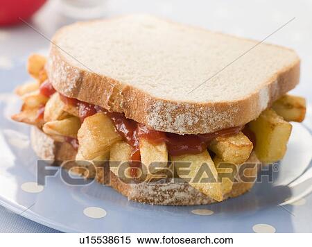 Stock Photography - Chip Sandwich on White Bread with Tomato Ketchup. Fotosearch