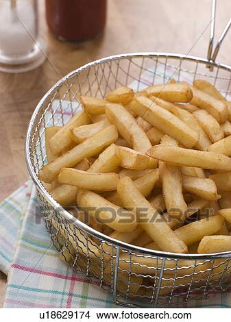 Picture - Chips in a Deep Frying Basket. Fotosearch