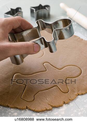 Stock Photo - Cutting out a Gingerbread Man. Fotosearch
