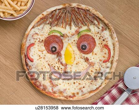 Stock Photo - Smiley Faced Pizza with a Portion of Chips. Fotosearch