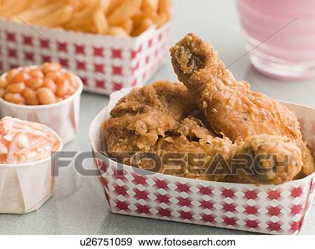 Stock Photo - Southern Fried Chicken Coleslaw Baked Beans Fries and Strawberry Milkshake. Fotosearch