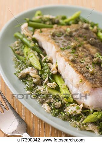 Stock Image - Fillet of Hake with Cockles Green Vegetables and Salsa Verde. Fotosearch