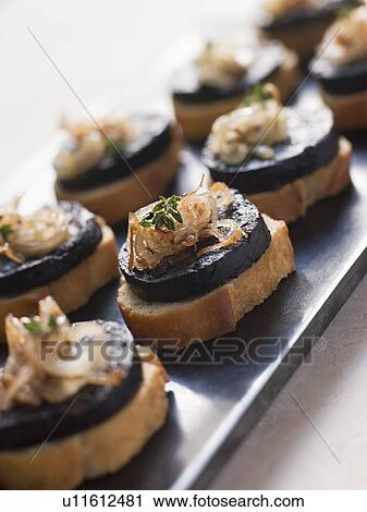Stock Image - Fried Spanish Morcilla and Onions. Fotosearch
