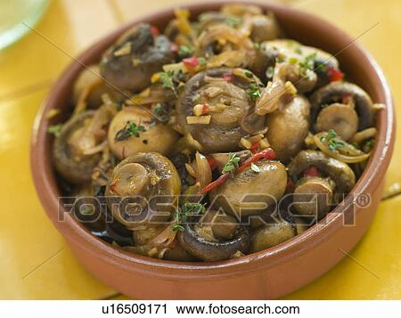 Stock Image - Garlic and Chilli Marinated Mushrooms. Fotosearch