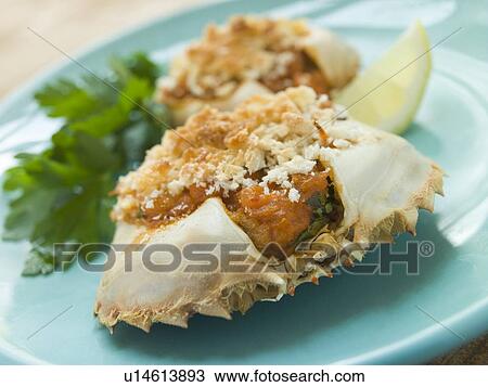 Stock Image - Plated Txangurro-Stuffed Crabs. Fotosearch