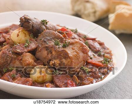 Stock Image - Rabbit Bread Chorizo Stew with Button Onions. Fotosearch