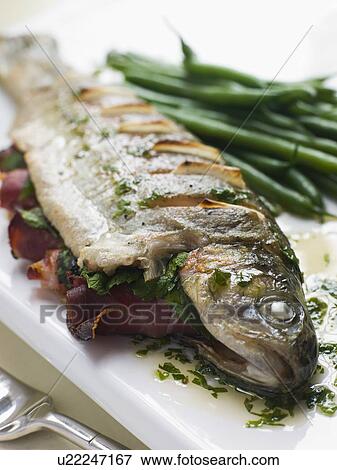 Stock Photo - Whole River Trout with Jamon and Herb Butter. Fotosearch