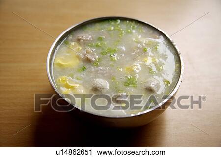 Stock Image - Close-up of a bowl of pork porridge. Fotosearch