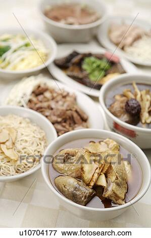 Stock Photo - Close-up of a bowl of sesame oil noodles and sesame oil chicken. Fotosearch
