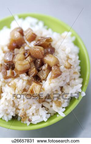 Stock Image - Close-up of braised pork rice in the bowl. Fotosearch