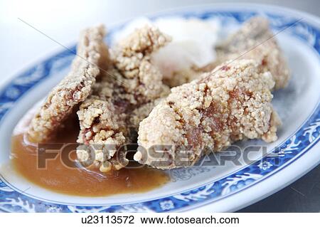 Stock Image - Close-up of fried eel on the plate. Fotosearch