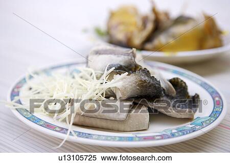 Stock Photography - Close-up of milk-fish skin on the plate. Fotosearch