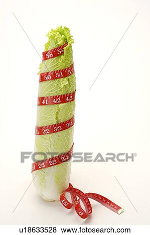 Stock Photo - Close-up of a bok choy twisted by a tape measure. Fotosearch