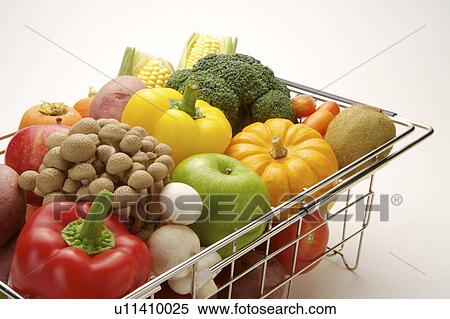 Stock Photography - Close-up of different kinds of vegetables and fruits in a container. Fotosearch