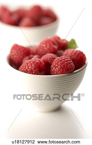 Stock Image - Close-up of raspberries in a bowl. Fotosearch