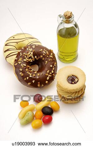 Stock Image - Different kinds of desserts and a bottle of olive oil. Fotosearch