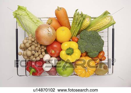 Stock Image - Different kinds of vegetables and fruits on a shelf. Fotosearch