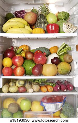 Stock Image - Close-up of a stack of fruits and vegetables in the refrigerator. Fotosearch