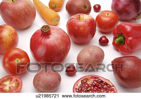 Stock Image - Close-up of different kinds of fruits and vegetables of red color. Fotosearch