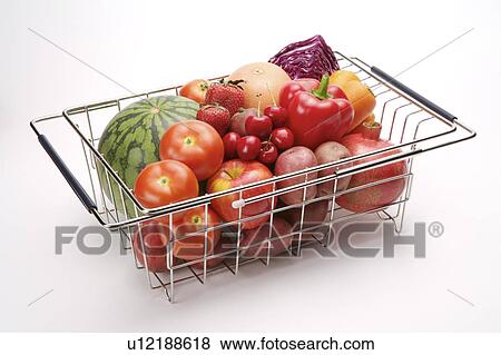 Stock Photo - Close-up of different kinds of fruits and vegetables in a basket. Fotosearch