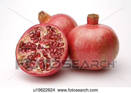 Picture - Close-up of two pomegranates and a half section. Fotosearch