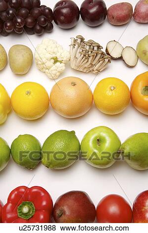 Stock Photo - Different kinds of fruits and vegetables in a row, close-up. Fotosearch