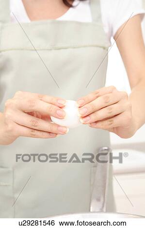Woman breaking an egg View Large Photo Image Stock Photograph - Woman breaking an egg. Fotosearch