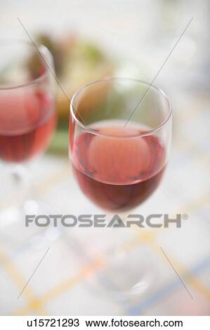 Stock Image - 2 Glasses of red wine. Fotosearch