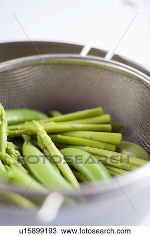 Asparagus and peas in a steamer View Large Photo Image Stock Image - Asparagus and peas in a steamer. Fotosearch