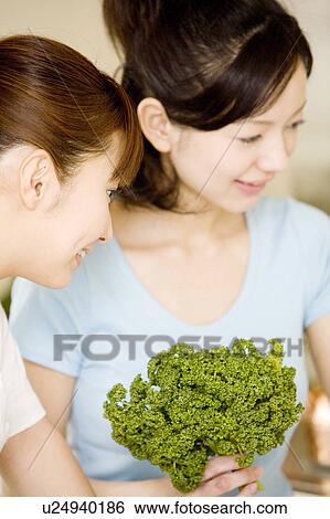 Two women in the kitchen View Large Photo Image Stock Photograph - Two women in the kitchen. Fotosearch