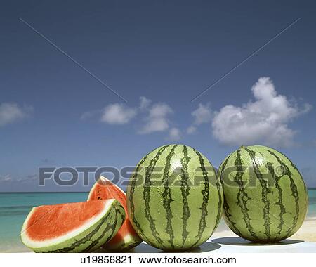 Stock Image - Watermelon on a beach. Fotosearch