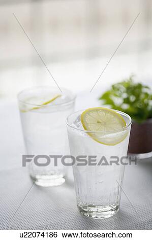 Stock Photograph - Two glasses of water with lemon garnish. Fotosearch