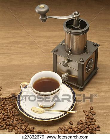 Stock Photo - Coffee grinder, beans, and cup. Fotosearch