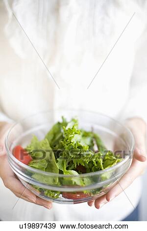 Stock Photo - Holding salad bowl. Fotosearch