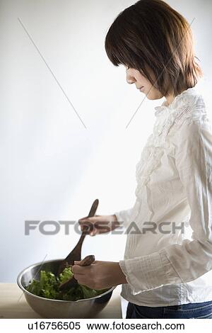 Young woman cooking salad View Large Photo Image Stock Photography - Young woman cooking salad. Fotosearch