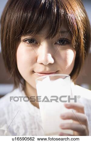 Stock Image - Young woman drinking soda. Fotosearch