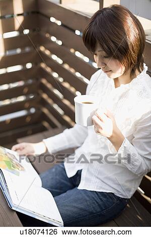 Young woman reading book View Large Photo Image Stock Photograph - Young woman reading book. Fotosearch