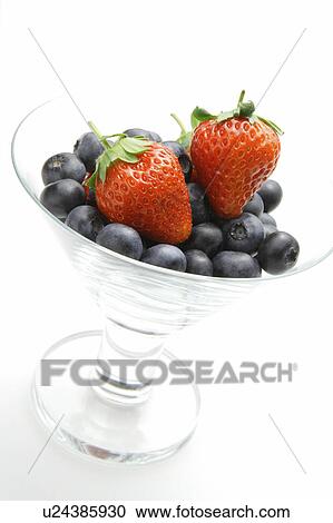 Stock Image - Glass with strawberries and blueberries. Fotosearch