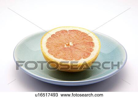 Stock Image - Half grapefruit on plate. Fotosearch