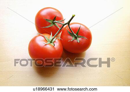 Stock Image - Three tomatoes. Fotosearch