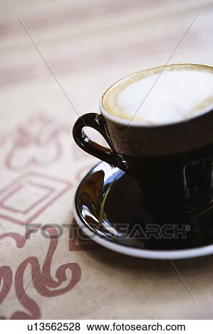 Close-up of a coffee cup on a saucer View Large Photo Image Stock Photo - Close-up of a coffee cup on a saucer. Fotosearch