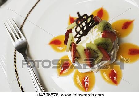 Close-up of a decorated dessert with a fork in a plate View Large Photo Image Stock Photograph - Close-up of a decorated dessert with a fork in a plate. Fotosearch
