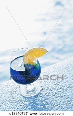 Close-up of a glass of cocktail on the ledge of swimming pool View Large Photo Image Stock Photo - Close-up of a glass of cocktail on the ledge of swimming pool. Fotosearch