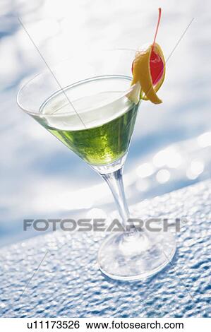 Close-up of a glass of cocktail on the ledge of a swimming pool View Large Photo Image Stock Photograph - Close-up of a glass of cocktail on the ledge of a swimming pool. Fotosearch