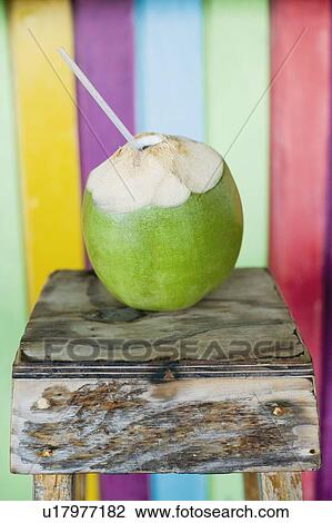 Close-up of a peeled coconut with a drinking straw View Large Photo Image Stock Image - Close-up of a peeled coconut with a drinking straw. Fotosearch